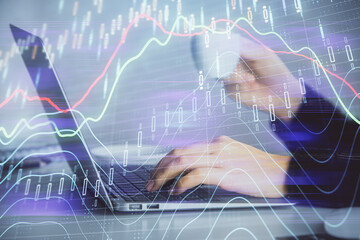 Double exposure of businesswoman hands typing on computer and forex graph hologram drawing. Financial analysis concept.
