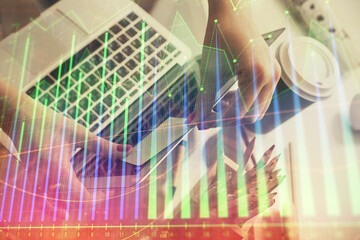Double exposure of businesswoman hands typing on computer and financial graph hologram drawing. Stock market analysis concept.