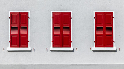 red shutter at white wall