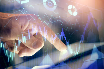Multi exposure of man's hands holding and using a phone and financial chart drawing. Market analysis concept.