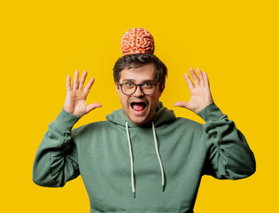 Guy in green hoodie with brain on yellow background