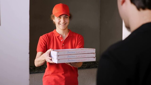 young woman rider delivering pizzas to a young man 