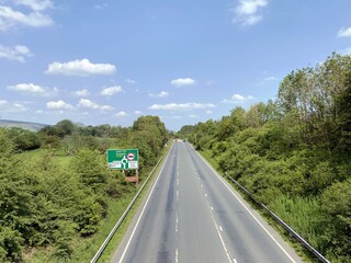 Looking on to the, A65 road, with trees, signs, and fine weather near, Skipton, Yorkshire, UK