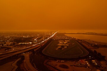 drone pictures of albany, CA beach with orange glow due to wildfires