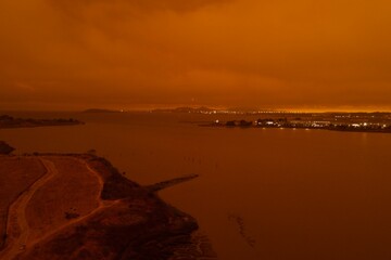 drone pictures of albany, CA beach with orange glow due to wildfires