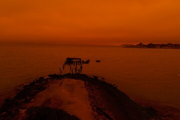 drone pictures of albany, CA beach with orange glow due to wildfires