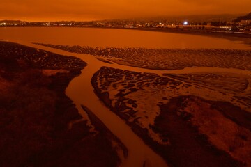 drone pictures of albany, CA beach with orange glow due to wildfires