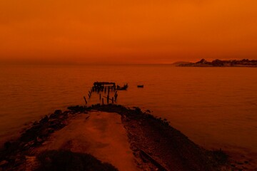 drone pictures of albany, CA beach with orange glow due to wildfires