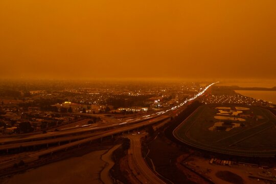 drone pictures of albany, CA beach with orange glow due to wildfires