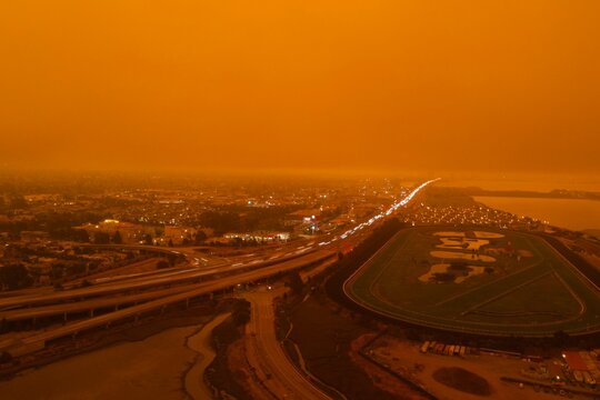 drone pictures of albany, CA beach with orange glow due to wildfires