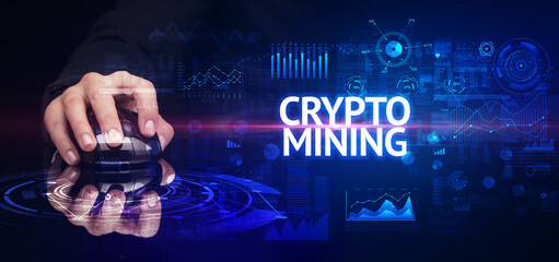 hand holding wireless peripheral with CRYPTO MINING inscription, modern technology concept