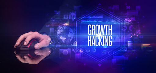 hand holding wireless peripheral with GROWTH HACKING inscription, cyber security concept