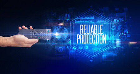hand holding wireless peripheral with RELIABLE PROTECTION inscription, cyber security concept