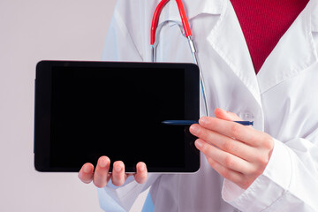 The doctor shows the information on the tablet. Medical recommendations. The doctor demonstrates the treatment scheme for the disease. Care of health. Place for your text.