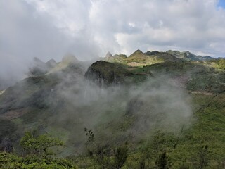 Clouds covering through the mountain tops on a sunny day