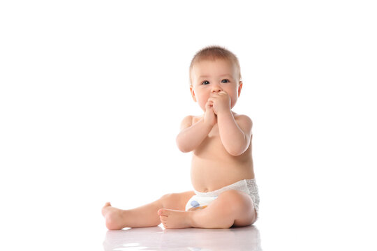 Cute little baby in diaper clapping hand on floor