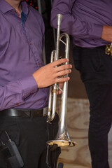 Obraz premium close-up of amusician hands while he is playing his trumpet. 