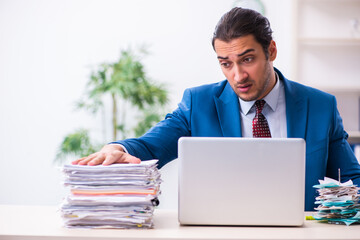 Young male employee unhappy with excessive work