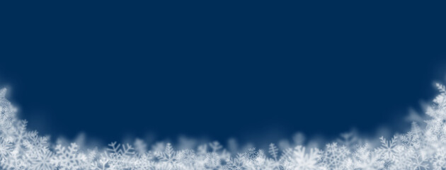 Christmas background of snowflakes of different shapes, sizes, blur and transparency on dark blue background
