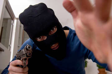 Male robber stealing valuable things from the house