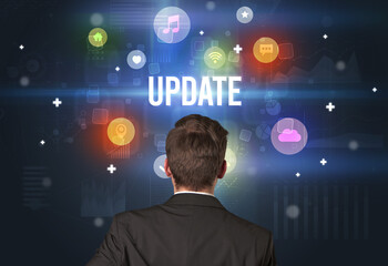 Rear view of a businessman with UPDATE inscription, modern technology concept