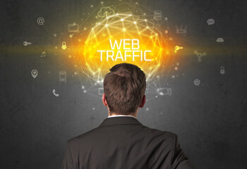 Rear view of a businessman with WEB TRAFFIC inscription, online security concept