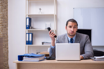 Young male businessman employee working in the office