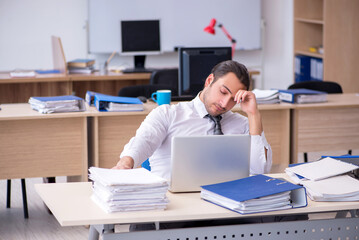 Young male employee unhappy with excessive work