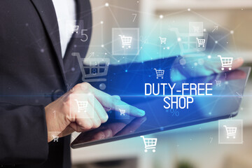 Fototapeta premium Young person makes a purchase through online shopping application with DUTY-FREE SHOP inscription