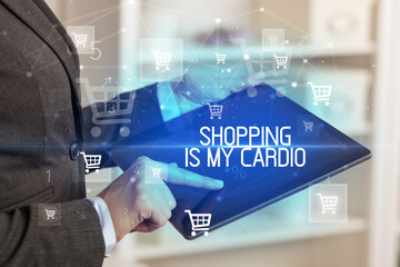 Young person makes a purchase through online shopping application with SHOPPING IS MY CARDIO inscription