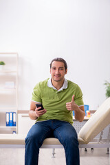 Young male patient waiting for doctor in the hospital