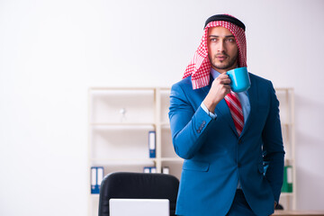 Young male arab employee working in office