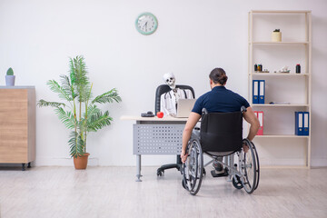 Young man in wheel-chair visiting dead doctor