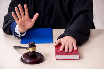 Young male judge working in courthouse