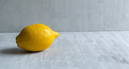 Ripe lemon on grey background