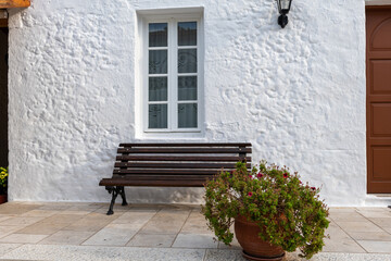 Fototapeta na wymiar white wash wall and bench.