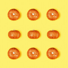 Creative pattern with small round pumpkin. Autumnal holiday concept, fall, harvest, thanksgiving, halloween.