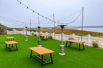 Outdoor beachfront restaurant in Half Moon Bay in the Bay Area with the Pacific Ocean in the...