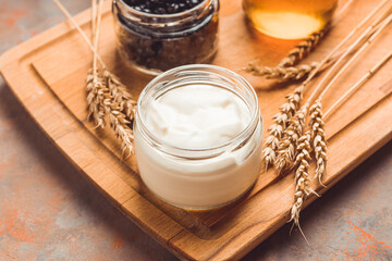Ingredients for making tasty and healthy dessert with greek yogurt, berries and honey. Selective focus.