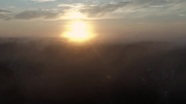 Sunrise Aerial Ascent Through Clouds