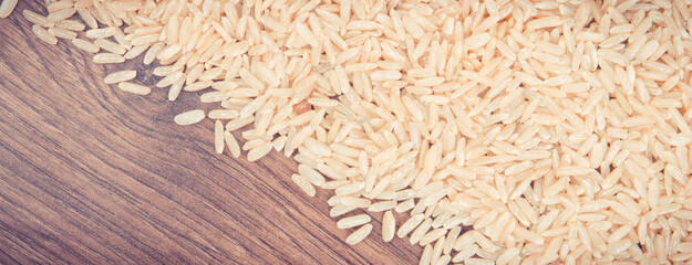 Vintage photo, Heap of brown rice, healthy nutrition concept, copy space for text on rustic board