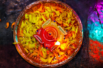 Indian Festival Diwali , lamp and marigold flower petals in pooja thali