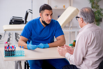 Old patient visiting young male doctor