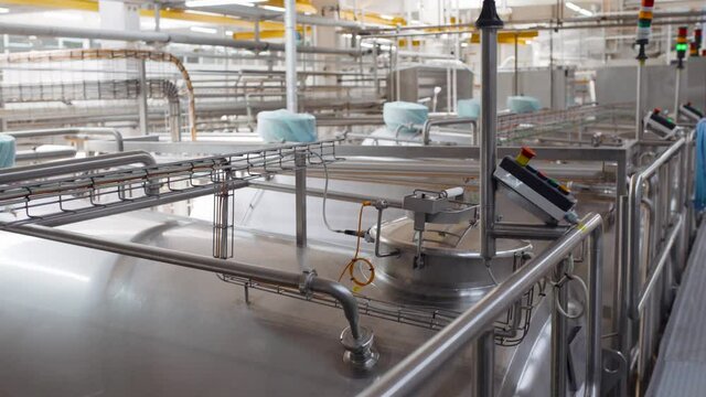 Stainless steel wine distilling tanks/cisterns. Steel barrels for fermentation of milk in factory
