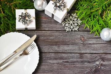 Christmas cutlery with a plate on a wooden background. New year and christmas concept.