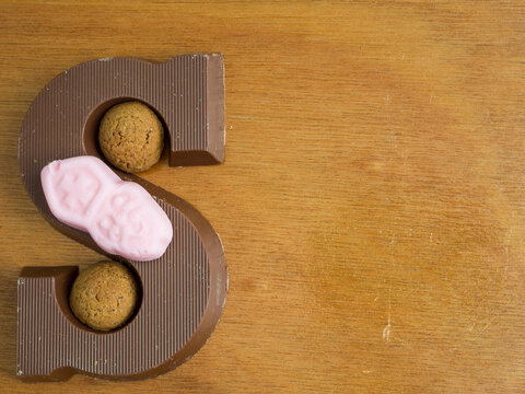 Composition for the dutch fest of Sinterklaas. With pepernoten and a chocolate letter S. Room for copy. 
