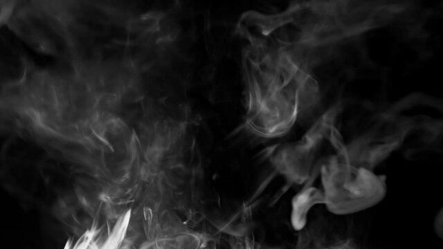 white smoke on a black background. Slow motion. Vape smoke. Texture of  cigarette smoke clud.