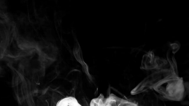 white smoke on a black background. Slow motion. Vape smoke. Texture of  cigarette smoke clud.