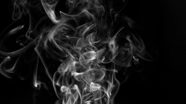 white smoke on a black background. Slow motion. Vape smoke. Texture of  cigarette smoke clud.