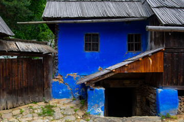clay and brick house with thatched roof and tile in the traditional and authentic mountain village